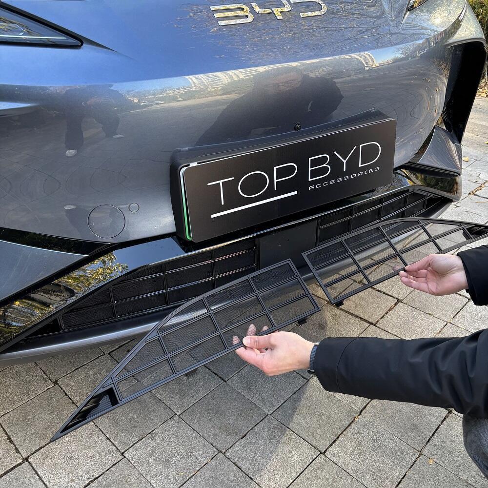 Black matte mesh lower bumper grille protector being installed on a grey BYD vehicle.