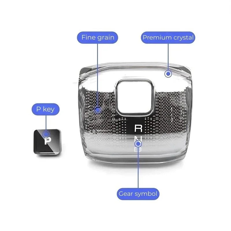 Premium transparent crystal gear shift knob with fine grain texture and silver gear symbols.