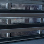 Black matte textured protective grille with fine metallic mesh inserts for BYD accessories.