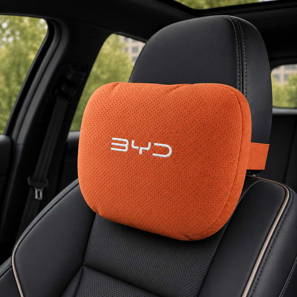 Orange car headrest pillow with BYD logo on a black car seat