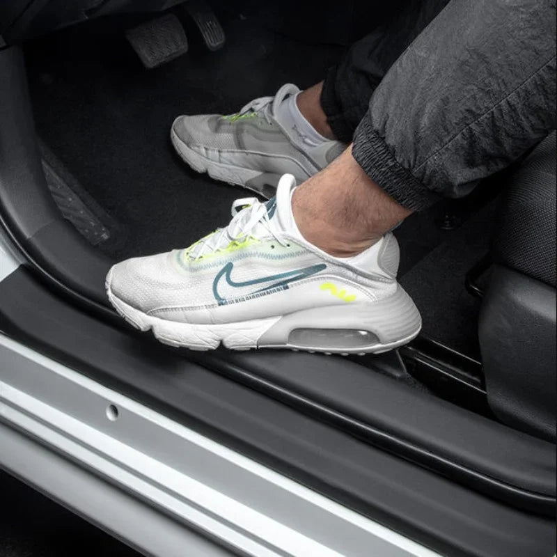 Black durable rubber door sill protector installed on a white car to prevent scratches.