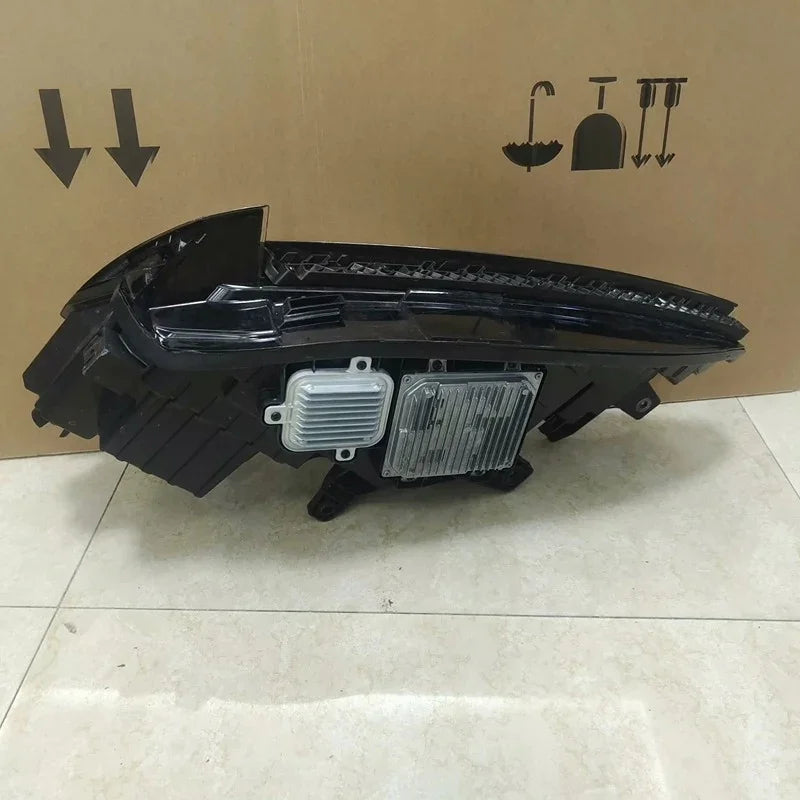 Sleek black replacement LED headlight assembly with silver metallic heat sink component.
