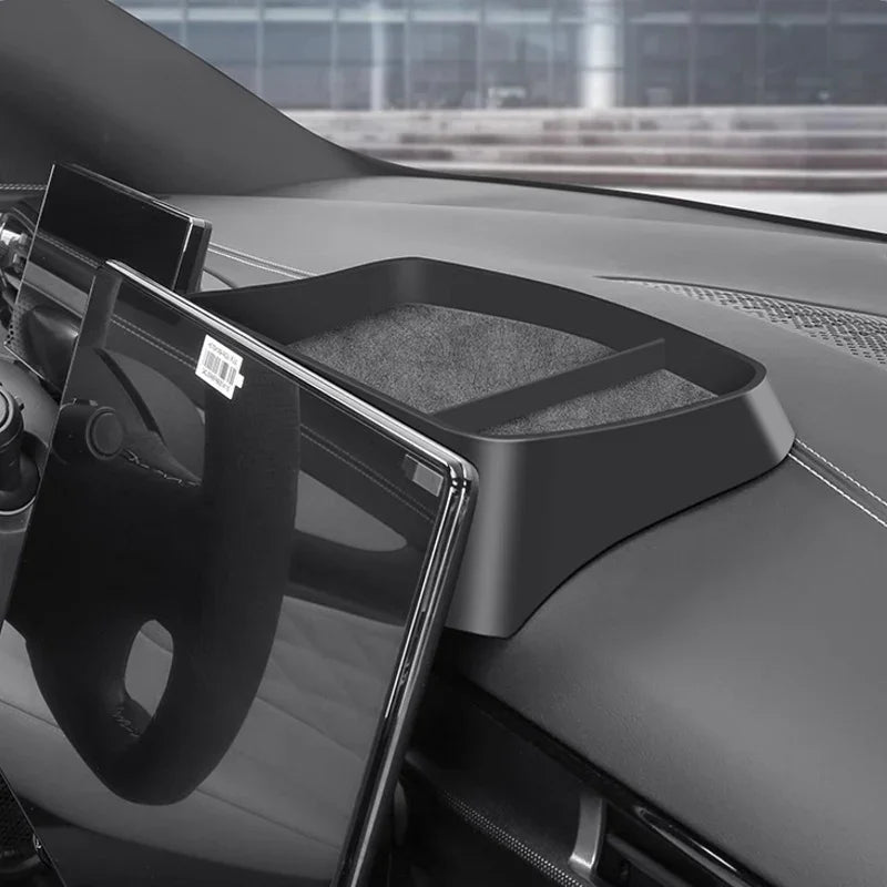 Black matte plastic dashboard storage tray with non-slip lining for BYD car interior.