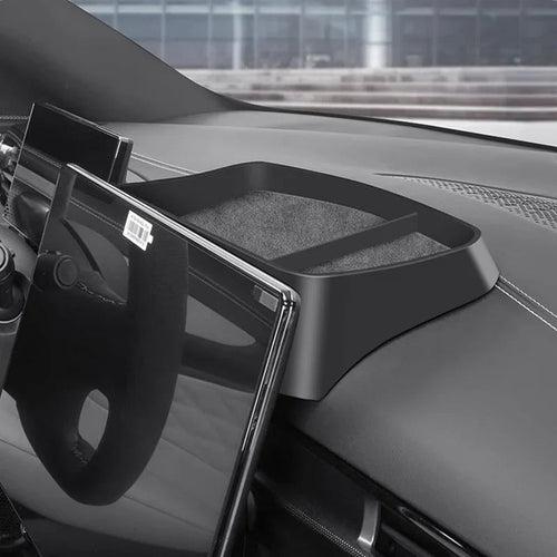 Black matte plastic dashboard storage tray with non-slip lining for BYD car interior.