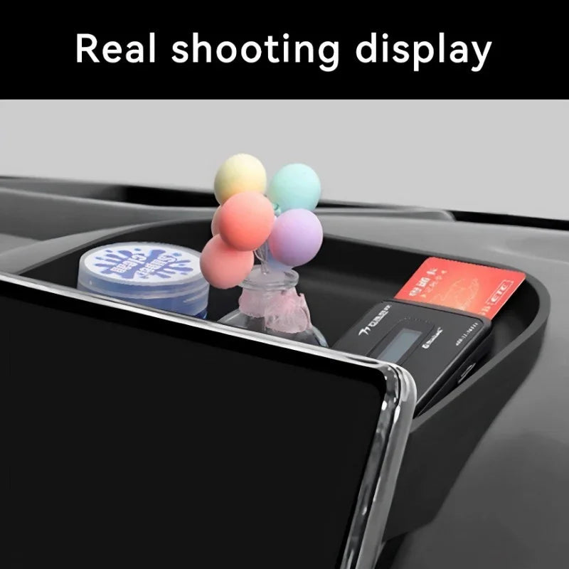 Black car center console organizer holding colorful decorative balls, a blue container, and an ETC card.