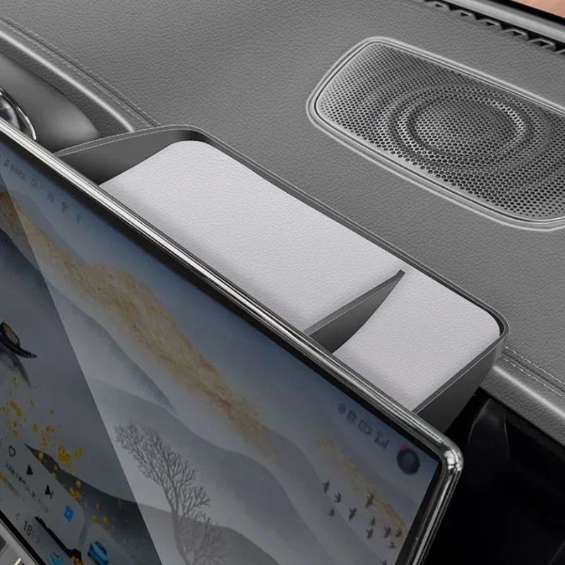 White foam padding inserted into a grey car interior storage compartment near the dashboard.