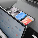 Black leather dashboard storage tray holding sunglasses, a blue book, and a red card.