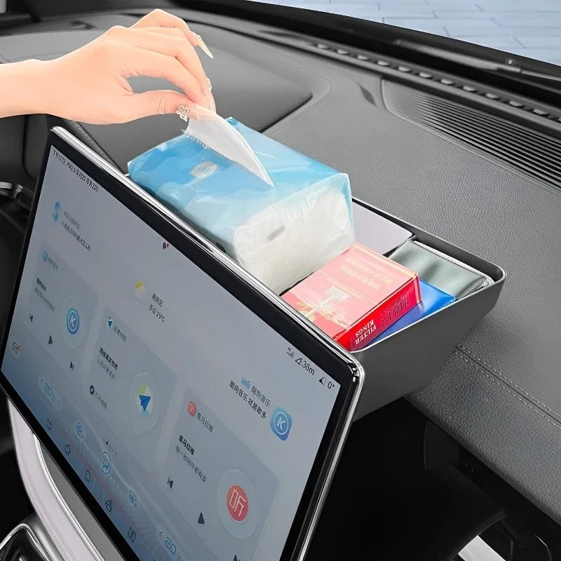 Black leather car dashboard organizer tray holding tissues and small essentials.
