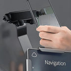 A hand holding a smartphone with a navigation map next to a black adjustable car phone mount installed on a dashboard.