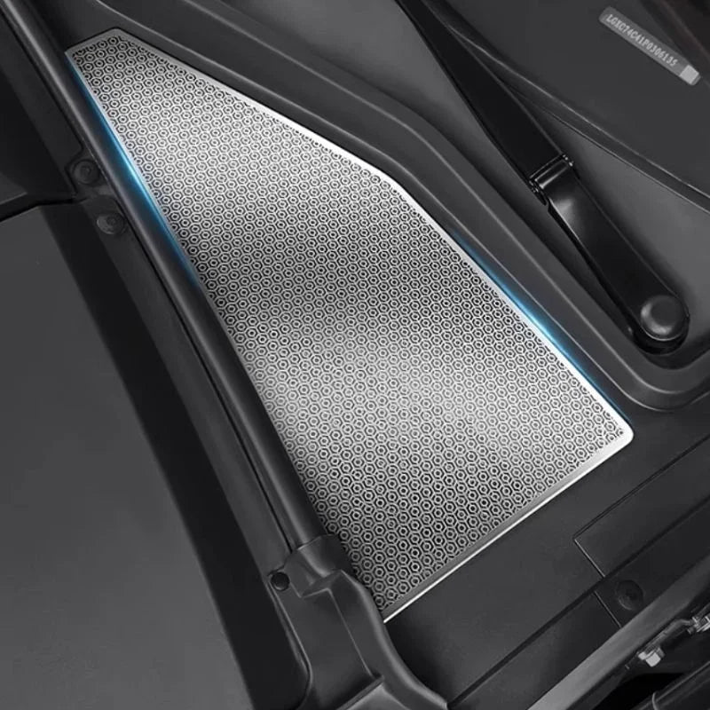 Silver stainless steel door sill protector with a textured honeycomb pattern and blue LED accent.