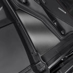 Close-up of a silver textured metal cargo liner installed in a black car trunk.