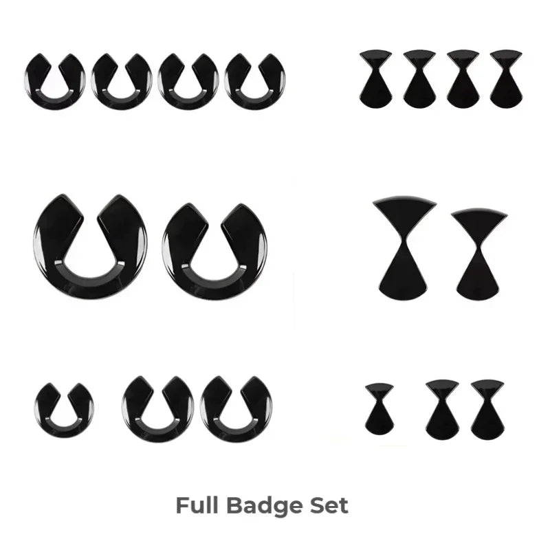 Black plastic BYD car interior emblem and badge set for vehicle customization.