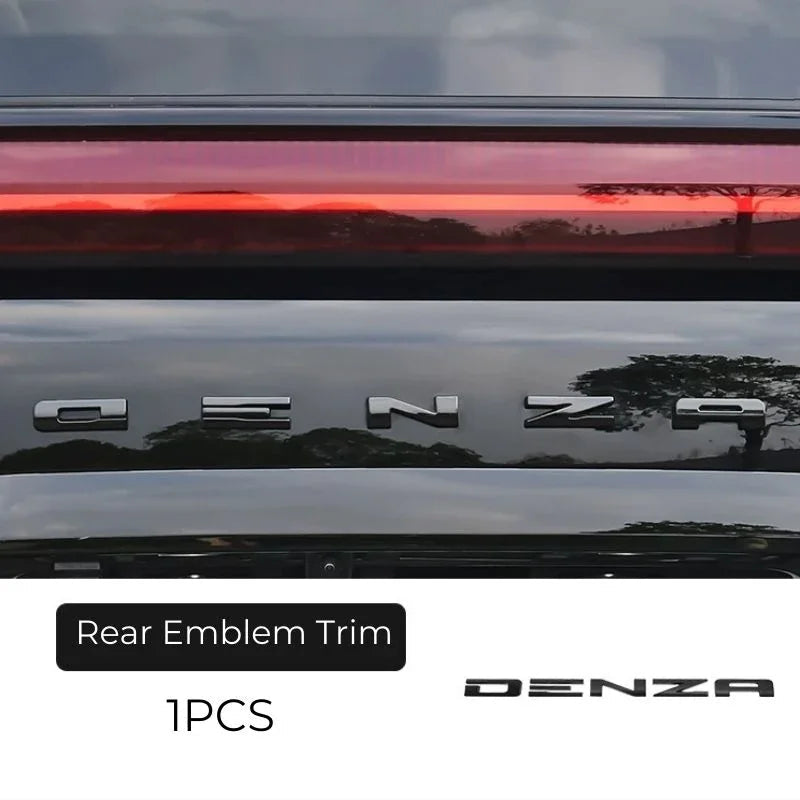 Chrome silver Denza rear emblem trim for premium car exterior styling.