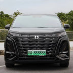 Front view of a sleek black Denza electric MPV featuring a glossy textured grille and LED headlights.