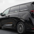 Glossy black BYD minivan featuring premium tinted windows and sleek multi-spoke silver alloy wheels.