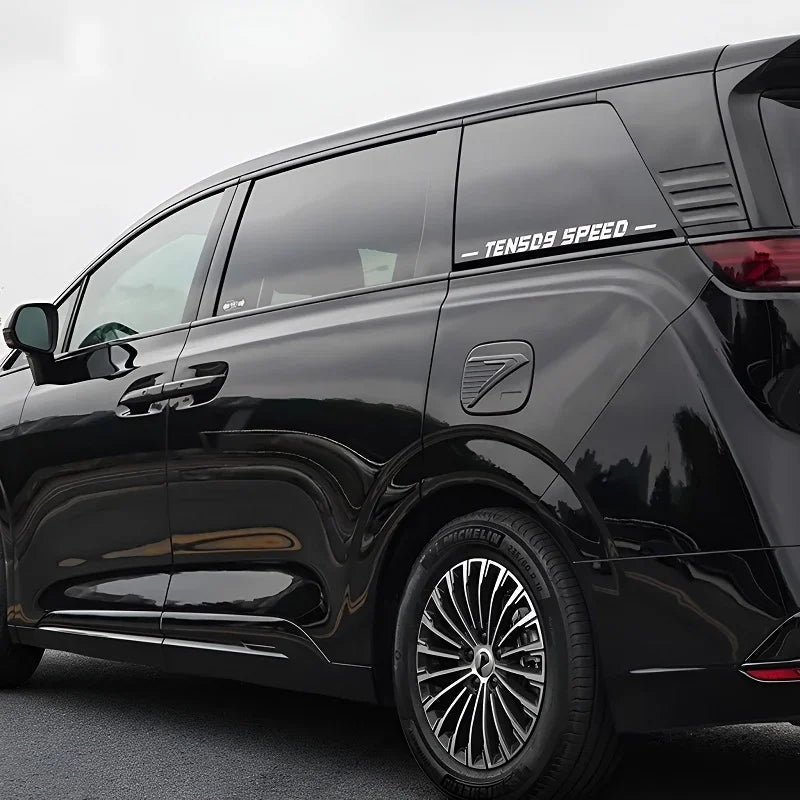 Glossy black BYD minivan featuring premium tinted windows and sleek multi-spoke silver alloy wheels.