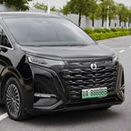 Glossy black BYD Denza MPV featuring a large textured grille and sleek LED headlights.