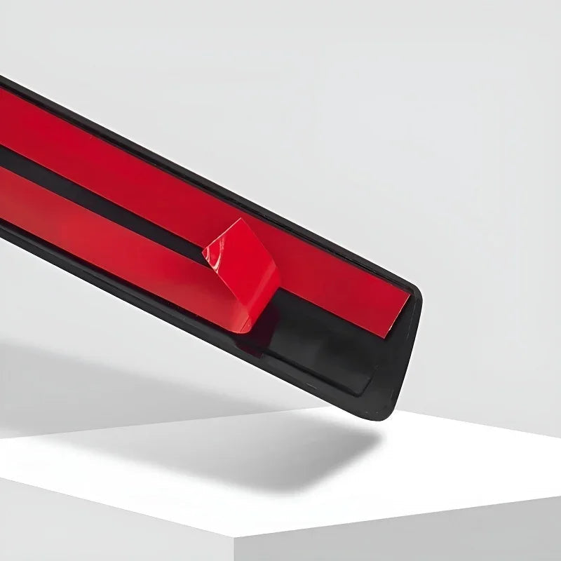 Red protective trim strip with black edging for car door edge protection.