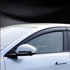 Sleek black tinted window deflectors installed on a white car for enhanced ventilation and style.