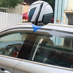 Sleek black shark fin antenna accessory installed on the roof of a silver car.