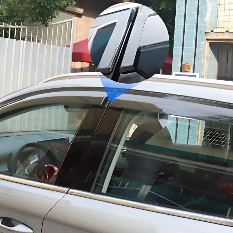 Sleek black shark fin antenna accessory installed on the roof of a silver car.