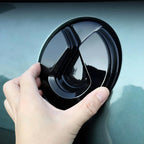 Glossy black fuel tank cover accessory for car, featuring a sleek, high-shine finish.