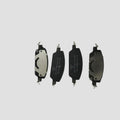 Four professional-grade black and silver metal brake pads for automotive braking systems.