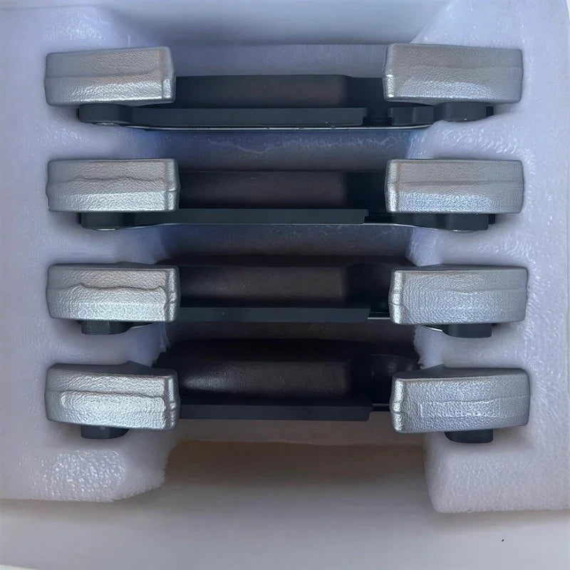 Set of four silver metallic door handle covers with textured black accents in protective foam.