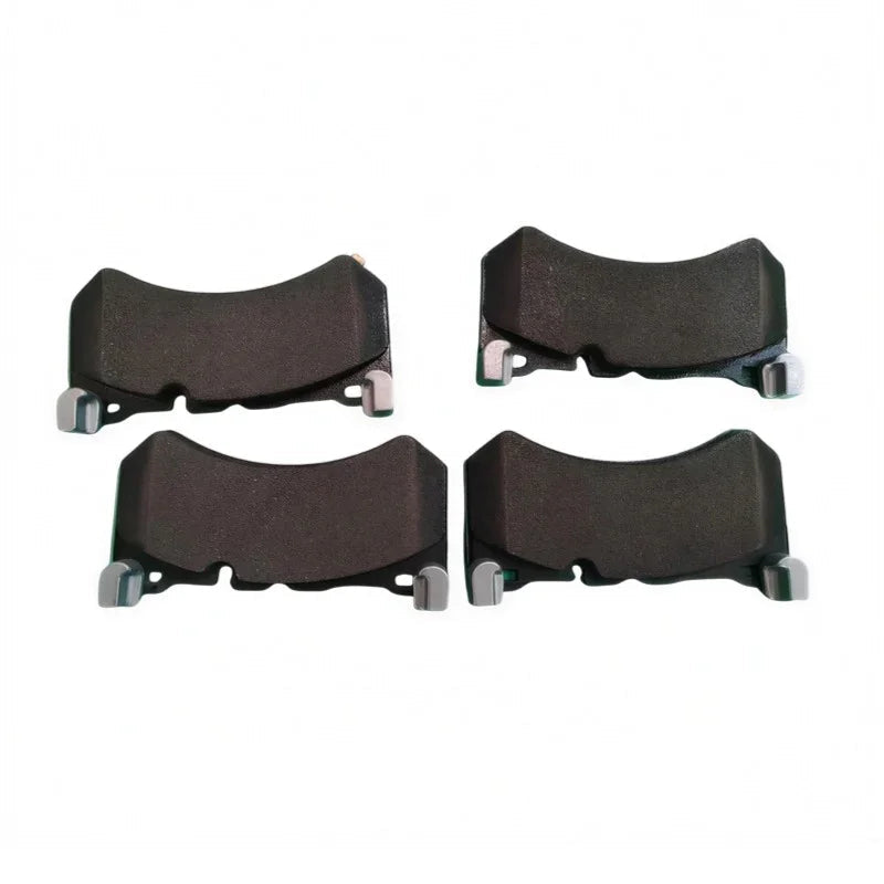 Set of four heavy-duty black brake pads with silver metal clips for BYD vehicle maintenance.