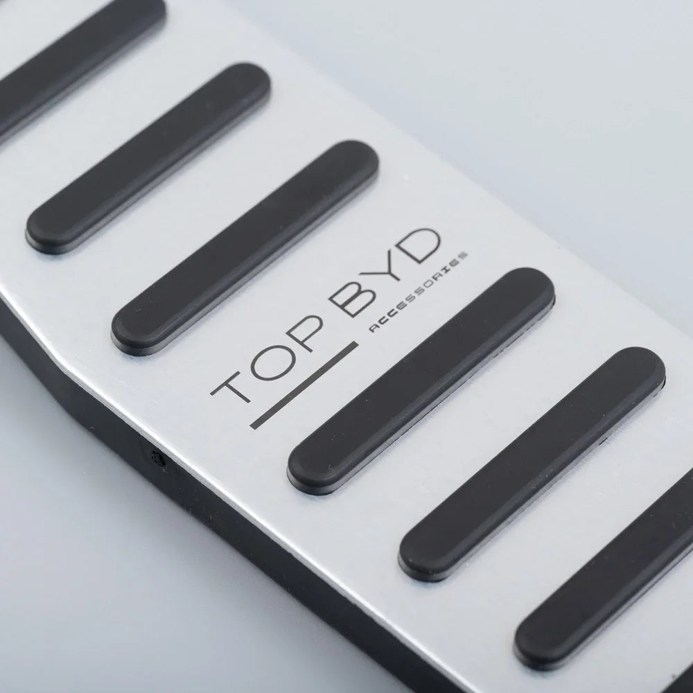Silver brushed aluminum pedal cover with black non-slip rubber grips for BYD accessories.