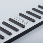 Silver aluminum car door sill plate with black anti-slip rubber strips and TOP BYD logo.
