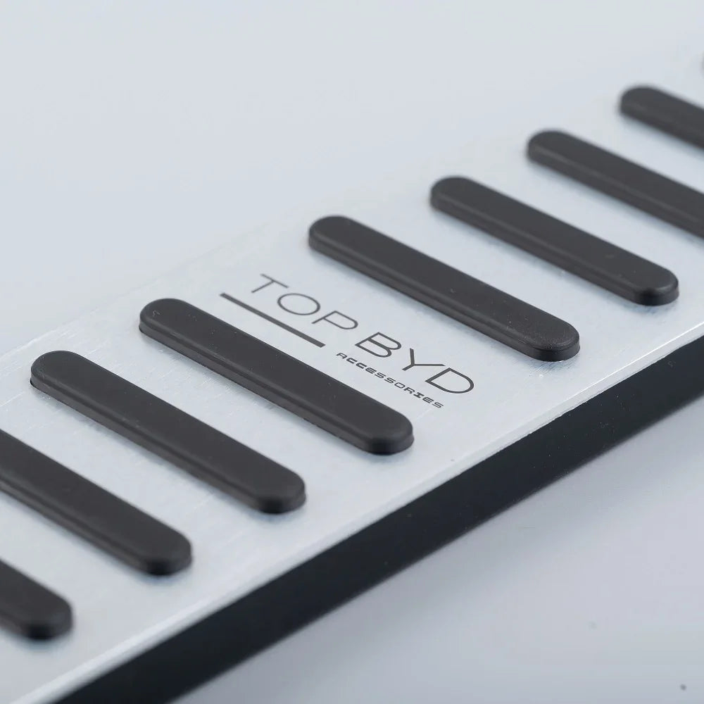 Silver aluminum car door sill plate with black anti-slip rubber strips and TOP BYD logo.