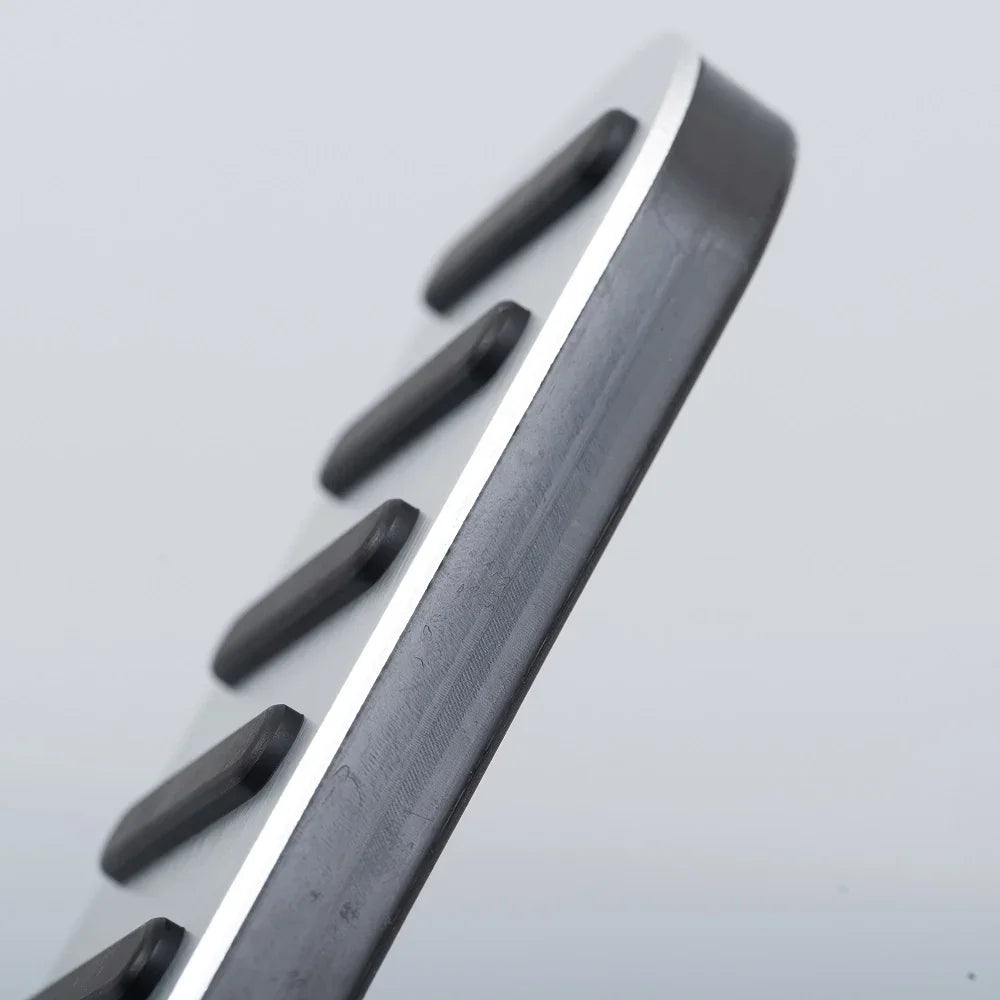 Silver metallic pedal plate with black anti-slip rubber inserts for enhanced grip.