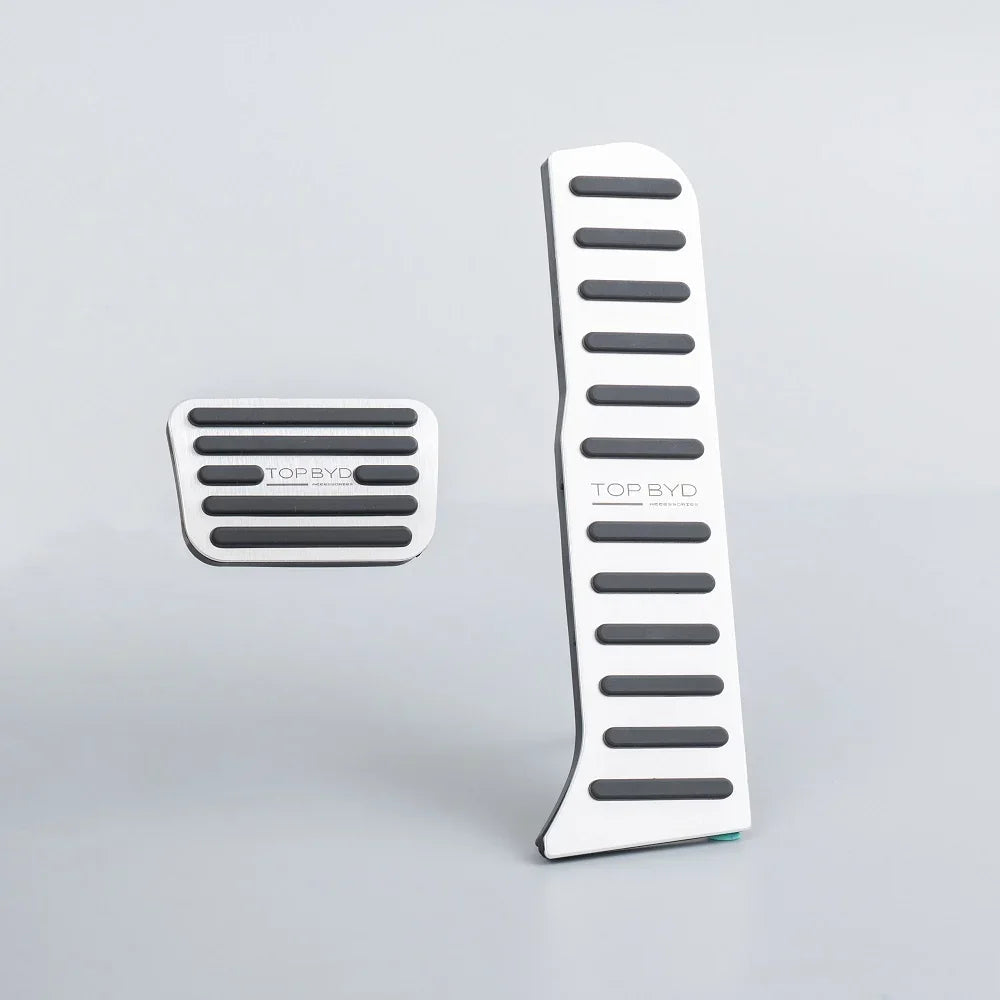 Silver aluminum alloy car pedals with black anti-slip rubber strips for BYD vehicles.