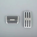 Silver brushed metal car pedal covers with black anti-slip rubber strips.