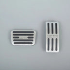 Silver brushed metal car pedal covers with black anti-slip rubber strips.