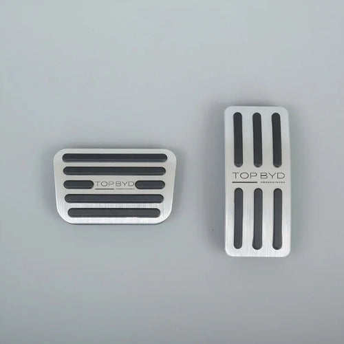 Silver brushed metal car pedal covers with black anti-slip rubber strips.