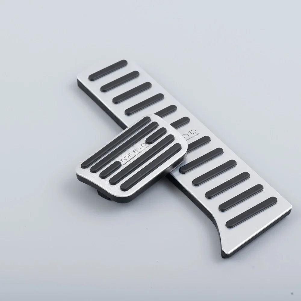 Silver aluminum alloy car pedals with black anti-slip rubber strips for BYD vehicles.