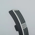 Black rubber and silver metal anti-slip car pedal accessory with textured grip.