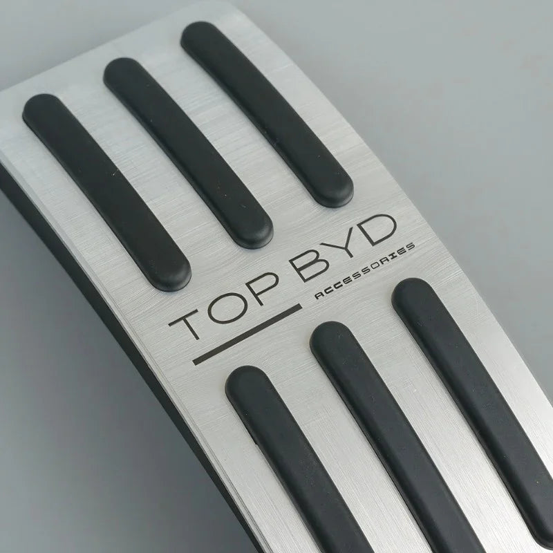 Silver brushed aluminum pedal covers with black non-slip rubber grips for BYD accessories.