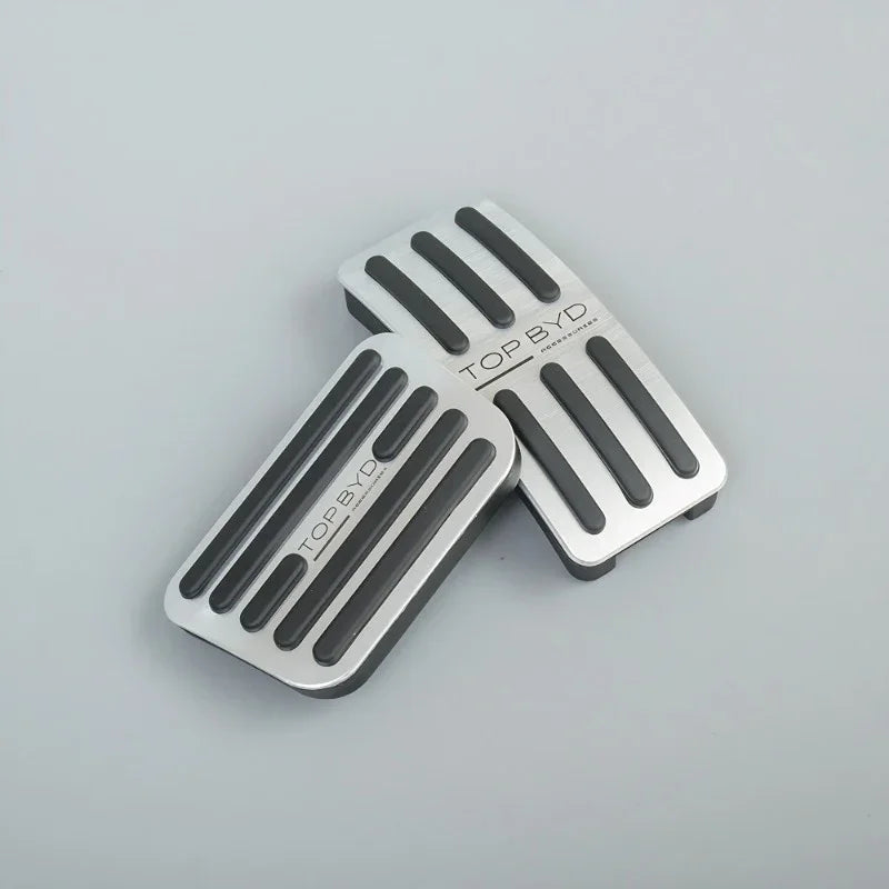 Silver aluminum alloy car pedal covers with black anti-slip rubber strips.