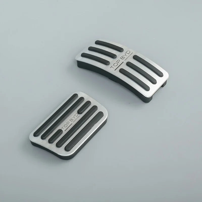 Silver brushed aluminum and black rubber anti-slip pedal covers for BYD vehicles.