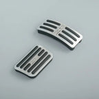 Silver brushed aluminum and black rubber anti-slip pedal covers for BYD vehicles.