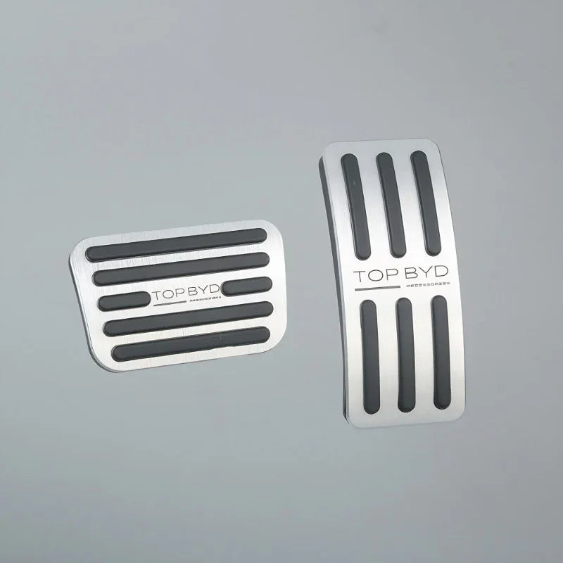 Silver stainless steel car pedal covers with black anti-slip rubber grips.