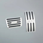 Silver stainless steel car pedal covers with black anti-slip rubber grips.
