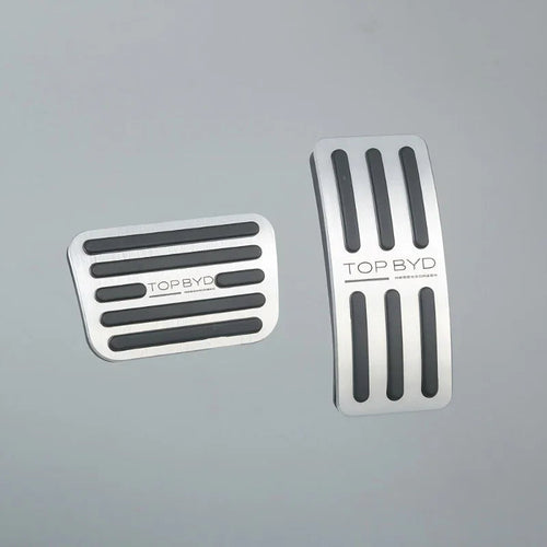 Silver stainless steel car pedal covers with black anti-slip rubber grips.