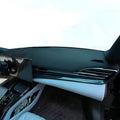 Modern car interior featuring a sleek black dashboard and white leather trim.