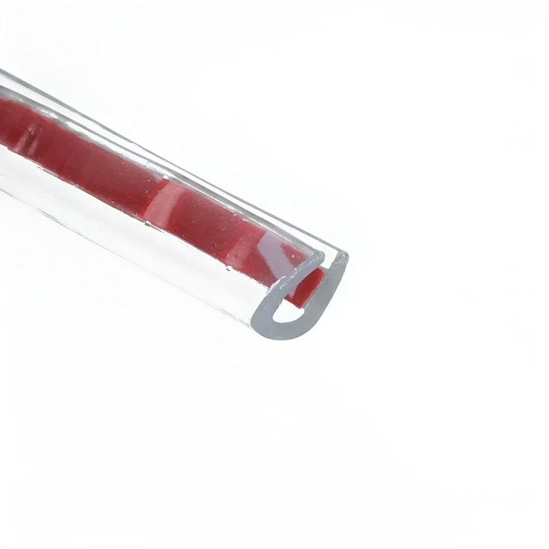 Close-up of a red protective trim strip encased in a clear plastic U-channel guard