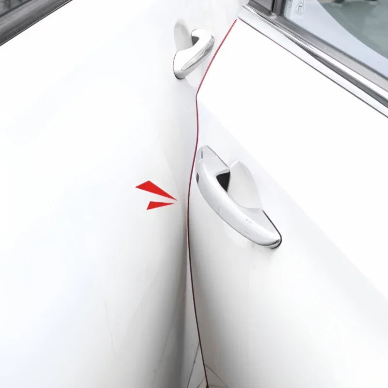 Close-up of white car door handles with a red decorative accent stripe.