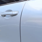 Close-up of a sleek, silver-colored car door handle with a smooth, metallic finish.